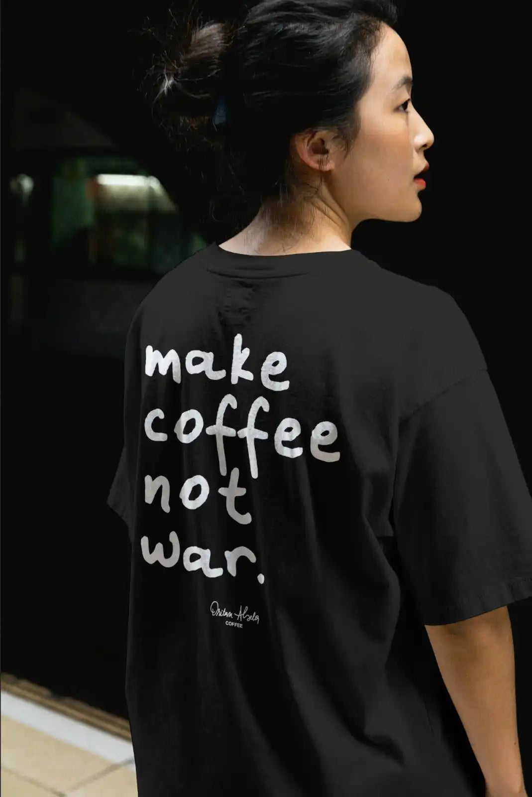 Black oversized t-shirt with a white graphic print on the back.