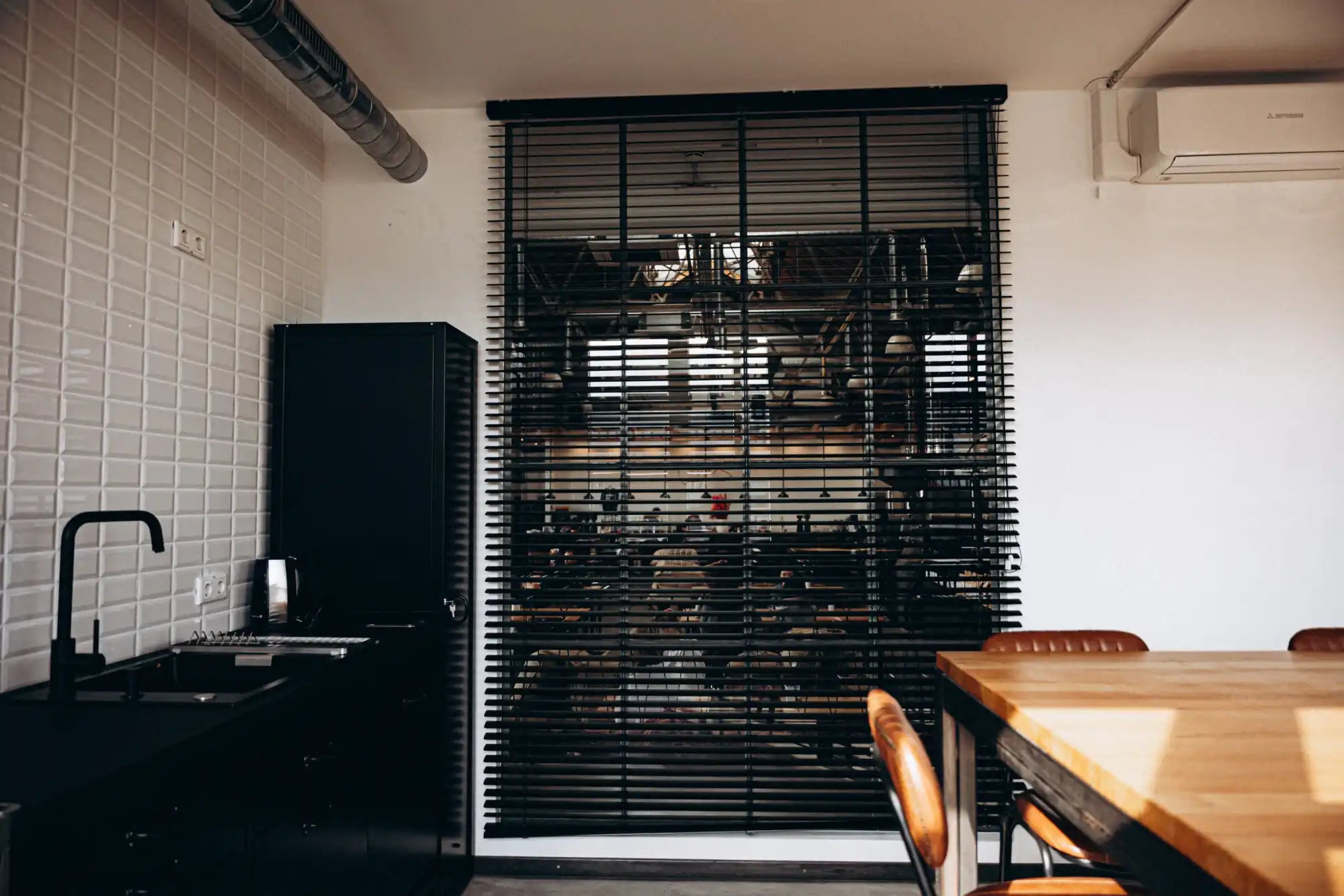 Black metal security gate with horizontal slats and modern design