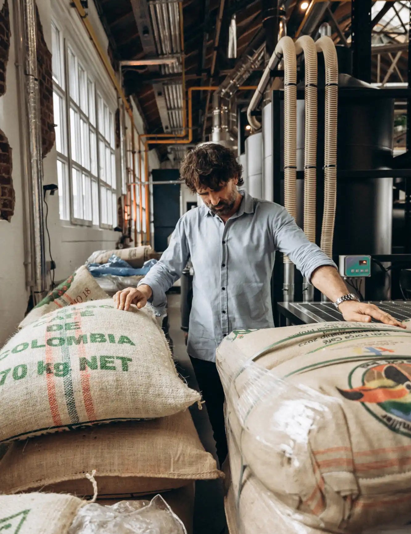 Man inspecting burlap sacks.