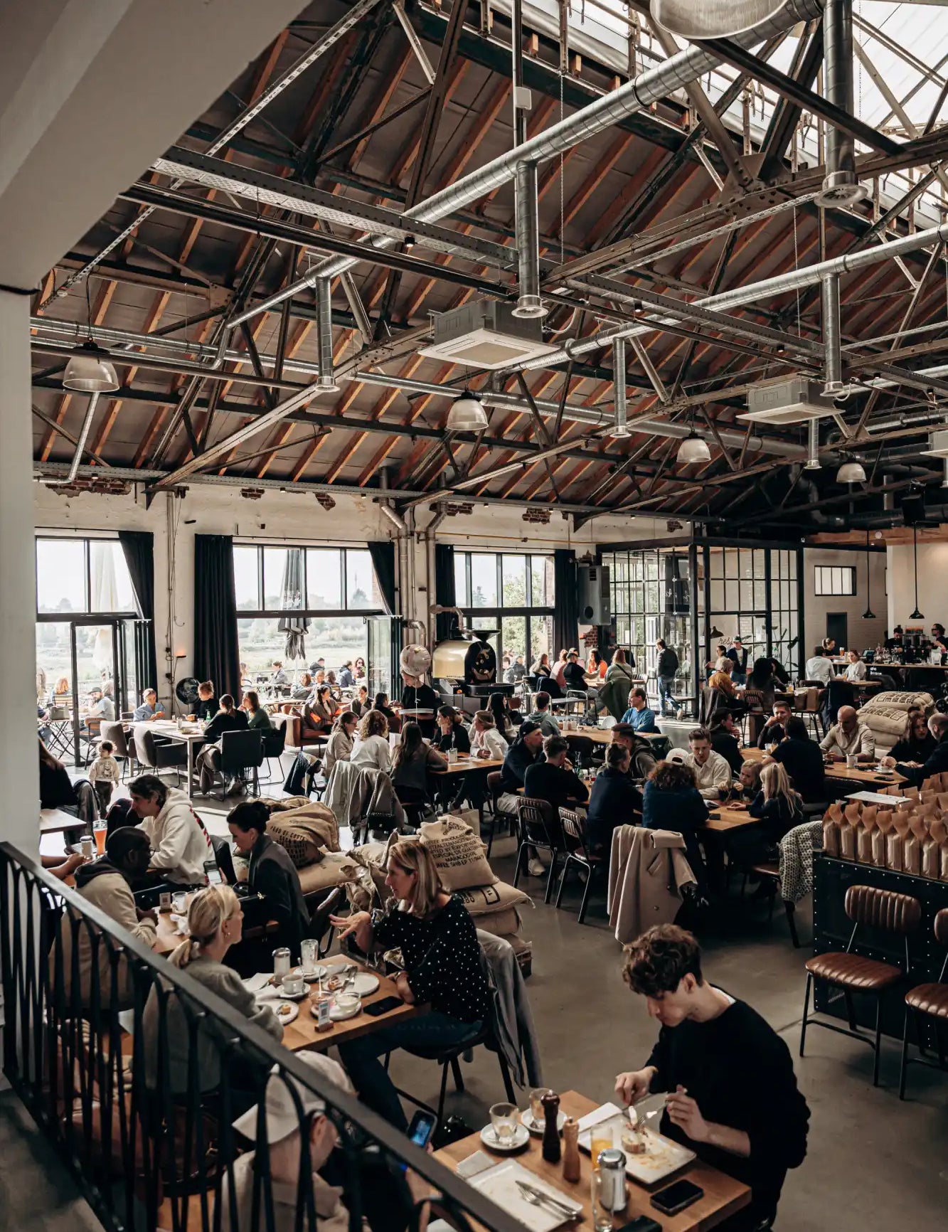 Wooden dining table with metal legs and chairs, rustic design.